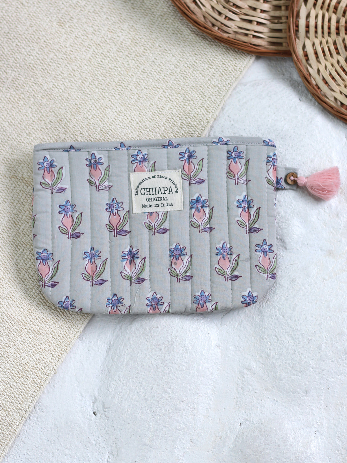 PINK FLOWER IN GRAY POUCH